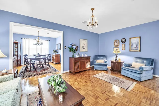 a kitchen with stainless steel appliances granite countertop a sink a stove cabinets and a kitchen island