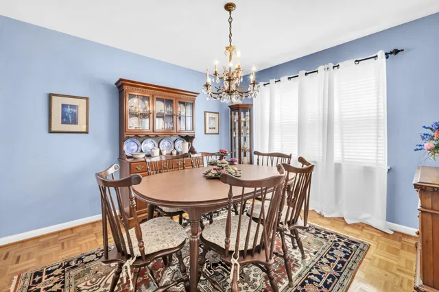 a dining room with furniture and wooden floor