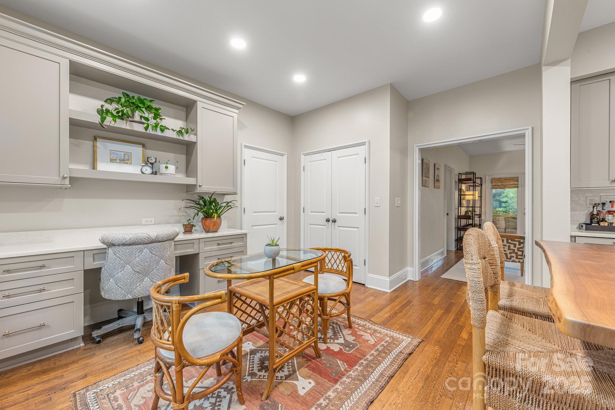 1025 Ardsley Road, Unit 104 Charlotte, NC 28207 - Photo 11 of 30 a living room with furniture a floor to ceiling window and wooden floor