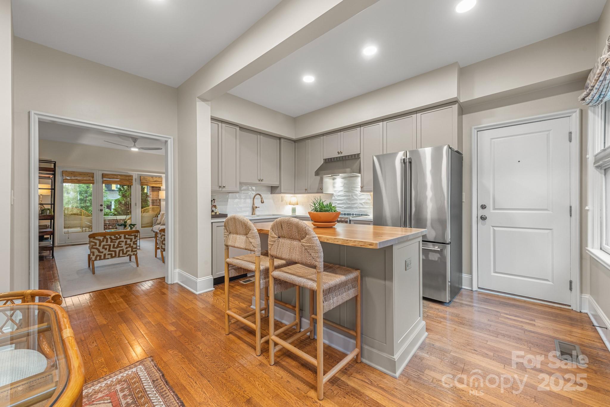 1025 Ardsley Road, Unit 104 Charlotte, NC 28207 - Photo 14 of 30 a room with a table chairs refrigerator and kitchen view