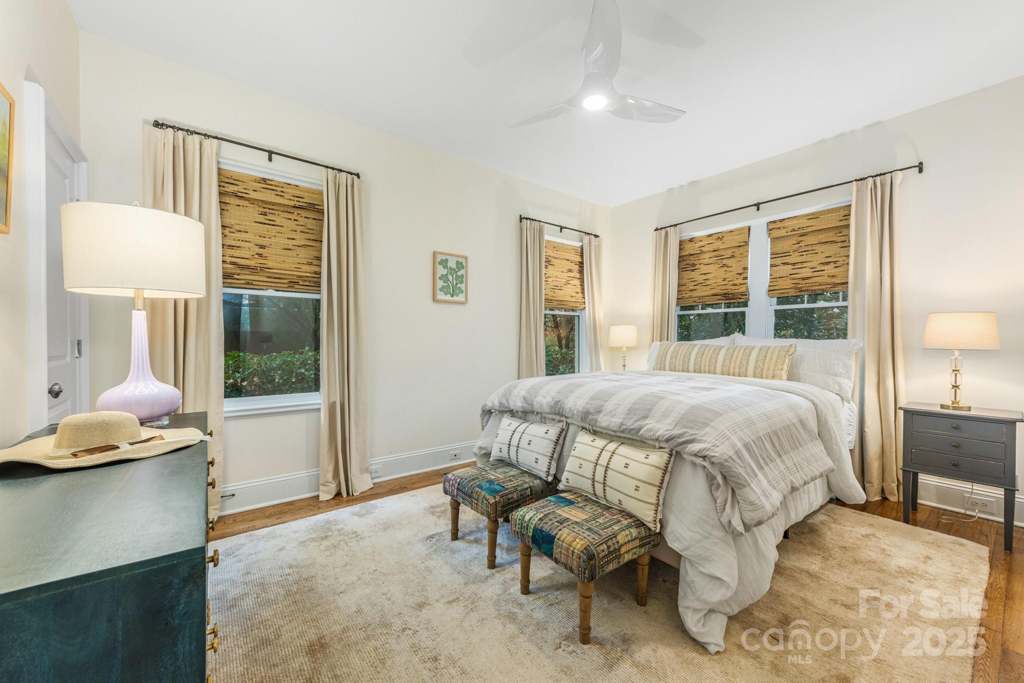 1025 Ardsley Road, Unit 104 Charlotte, NC 28207 - Photo 19 of 30 a bedroom with a bed and wooden floor