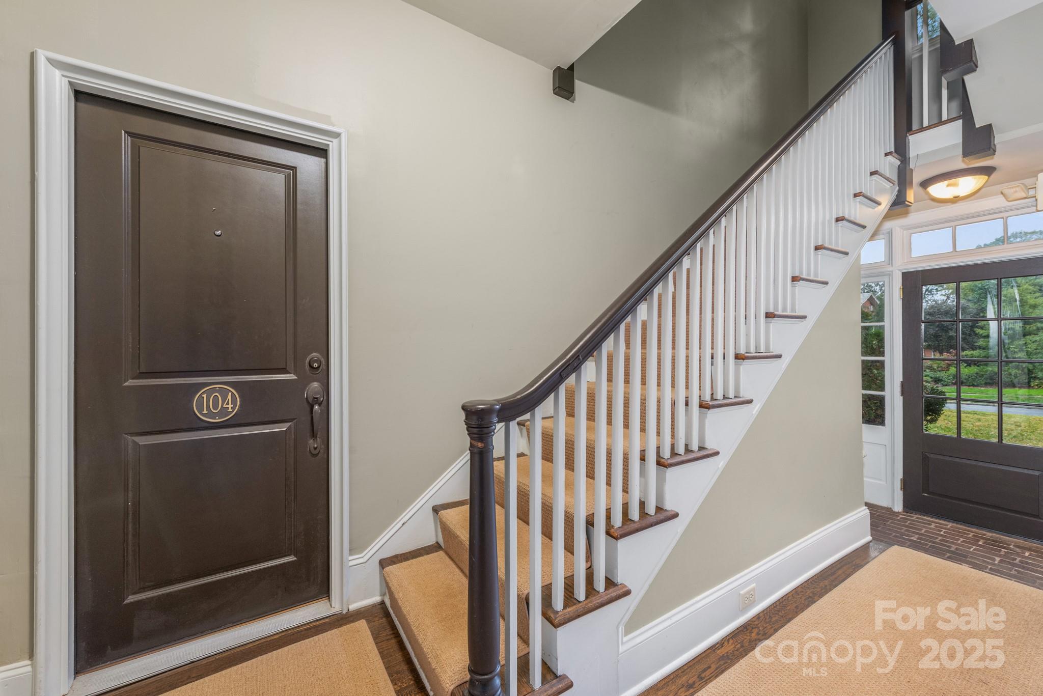 1025 Ardsley Road, Unit 104 Charlotte, NC 28207 - Photo 2 of 30 a view of staircase with wooden floor and door