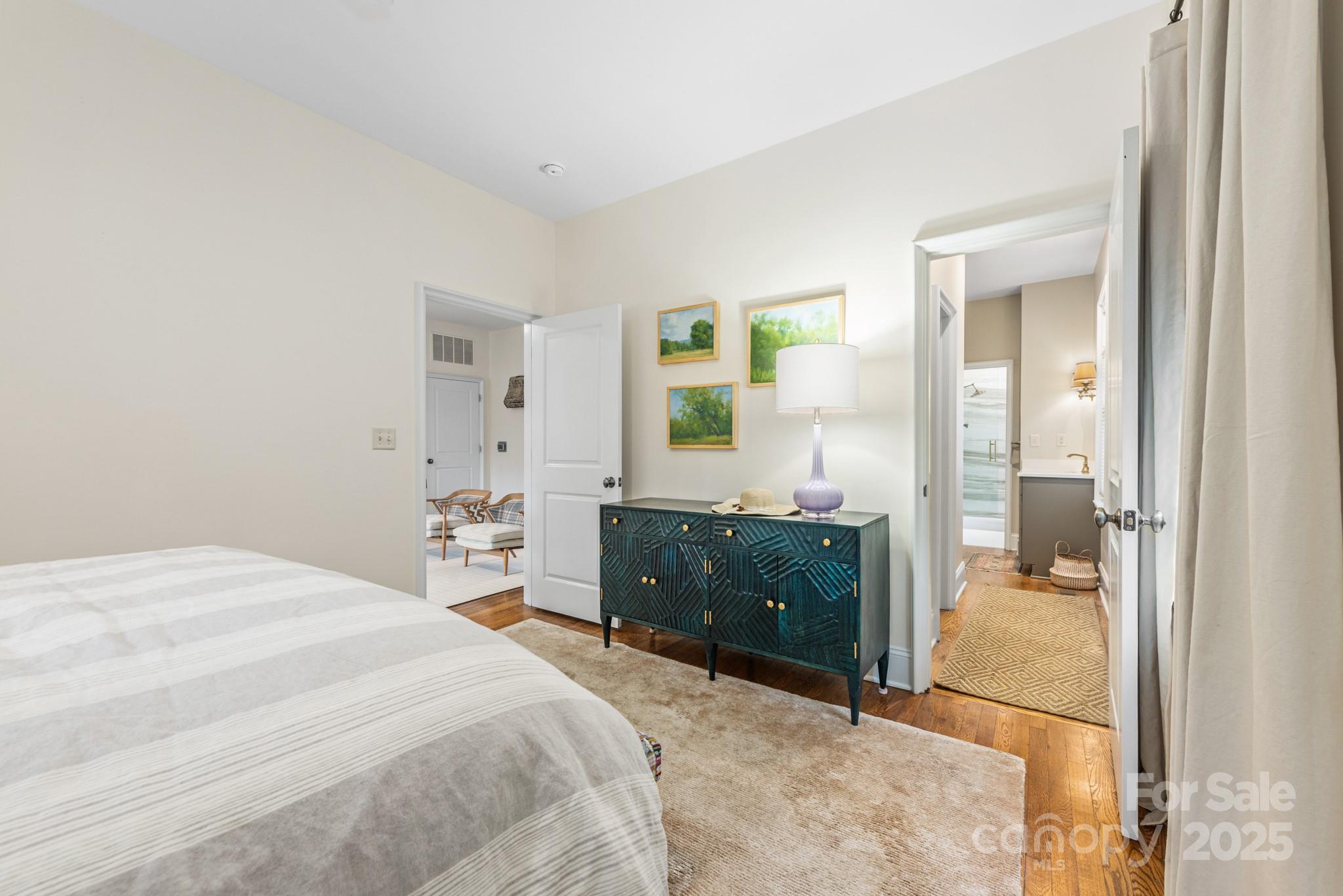 1025 Ardsley Road, Unit 104 Charlotte, NC 28207 - Photo 21 of 30 a bedroom with a bed and a mirror