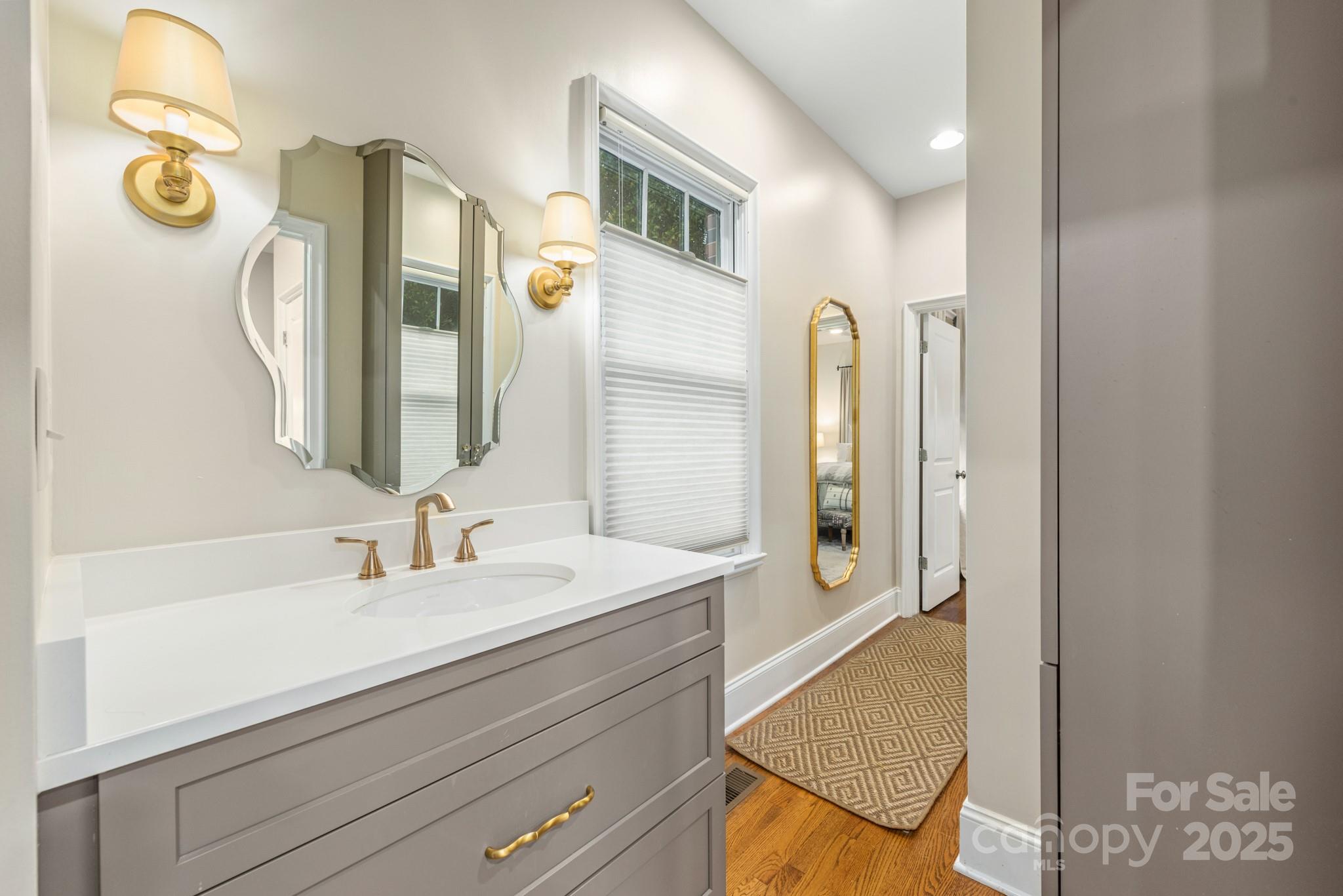 1025 Ardsley Road, Unit 104 Charlotte, NC 28207 - Photo 26 of 30 a bathroom with a sink and a mirror