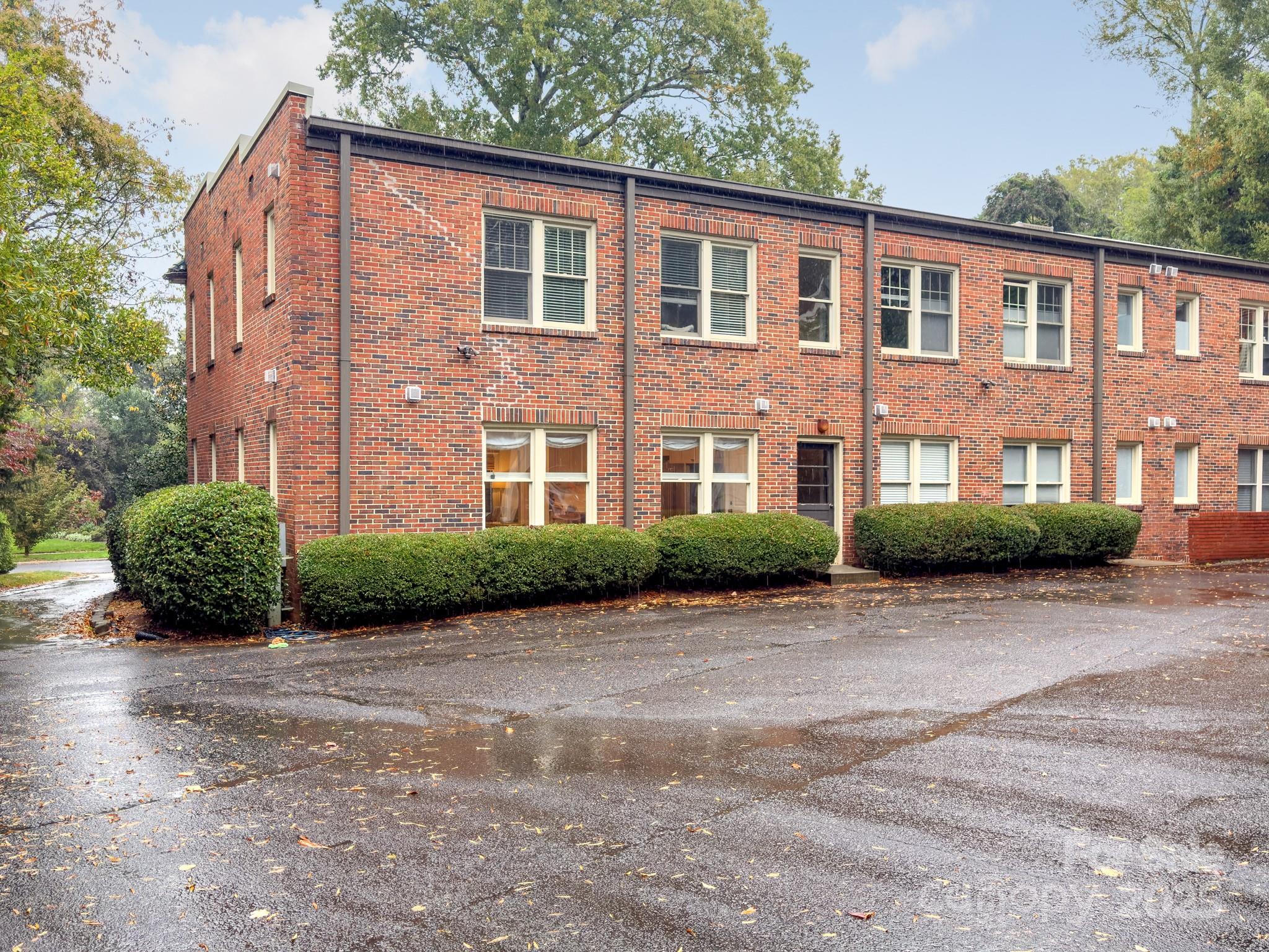 1025 Ardsley Road, Unit 104 Charlotte, NC 28207 - Photo 27 of 30 a view of a brick building next to a yard
