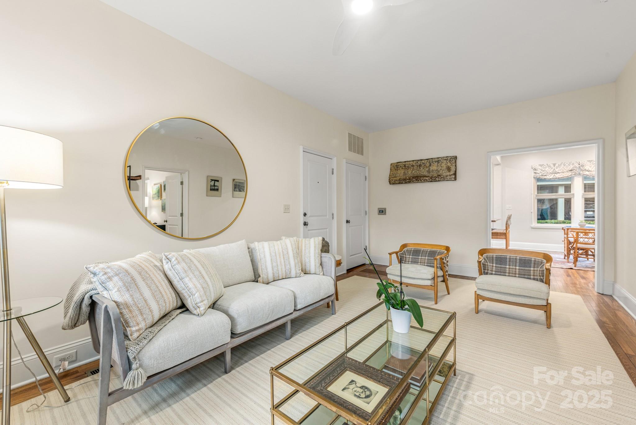 1025 Ardsley Road, Unit 104 Charlotte, NC 28207 - Photo 5 of 30 a living room with furniture a mirror and a large window