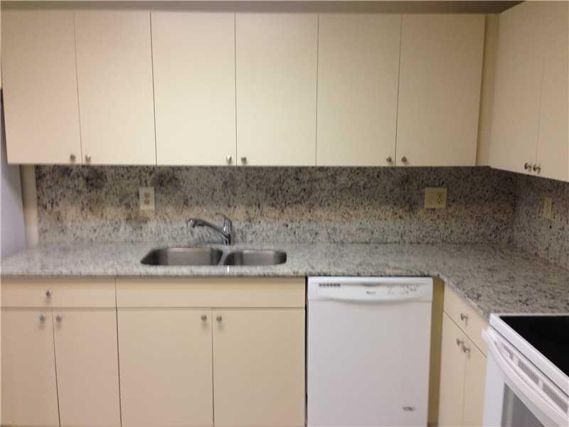 6542 Via Regina, Unit 11 Boca Raton, FL 33433 - Photo 4 of 11 a kitchen with a sink and cabinets