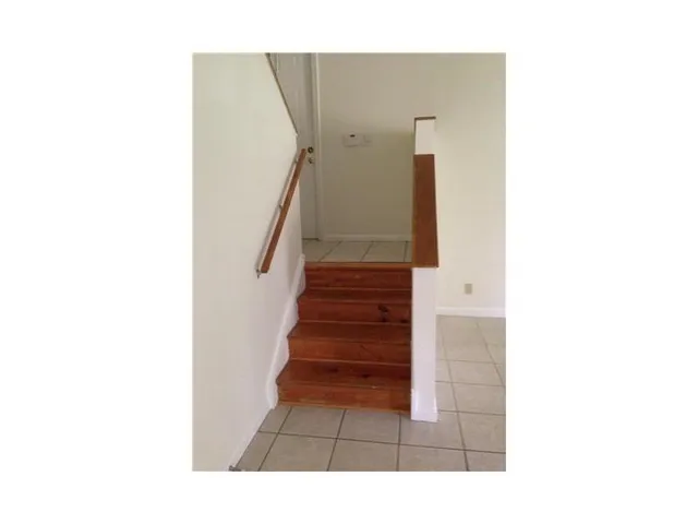 a view of staircase with white walls