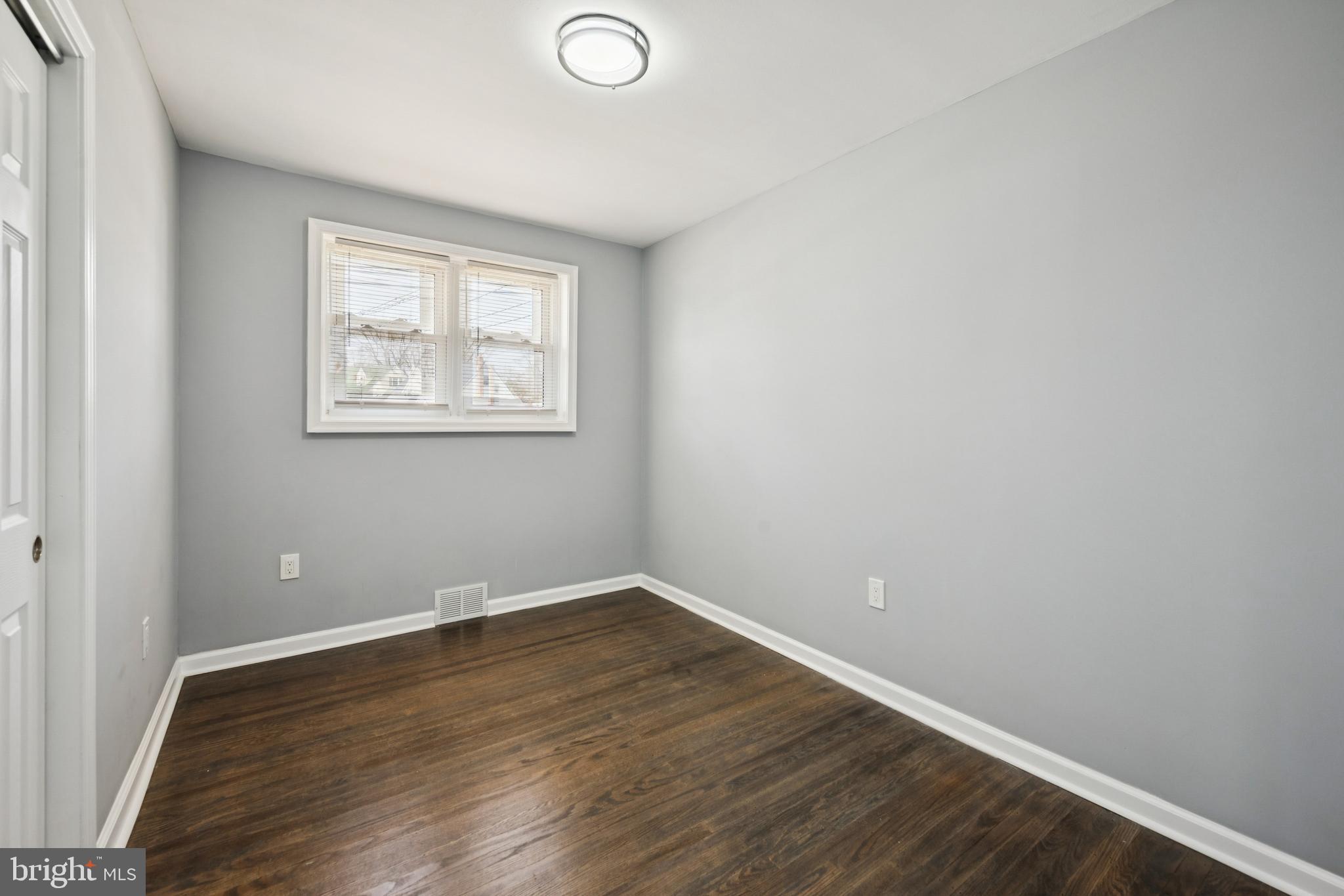 500 West Charles Street Palmyra, NJ 08065 - Photo 16 of 26 an empty room with wooden floor and windows