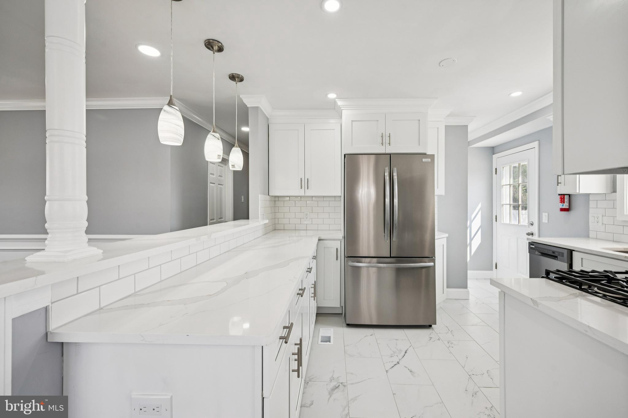 500 West Charles Street Palmyra, NJ 08065 - Photo 5 of 26 a kitchen with stainless steel appliances a refrigerator and a stove top oven