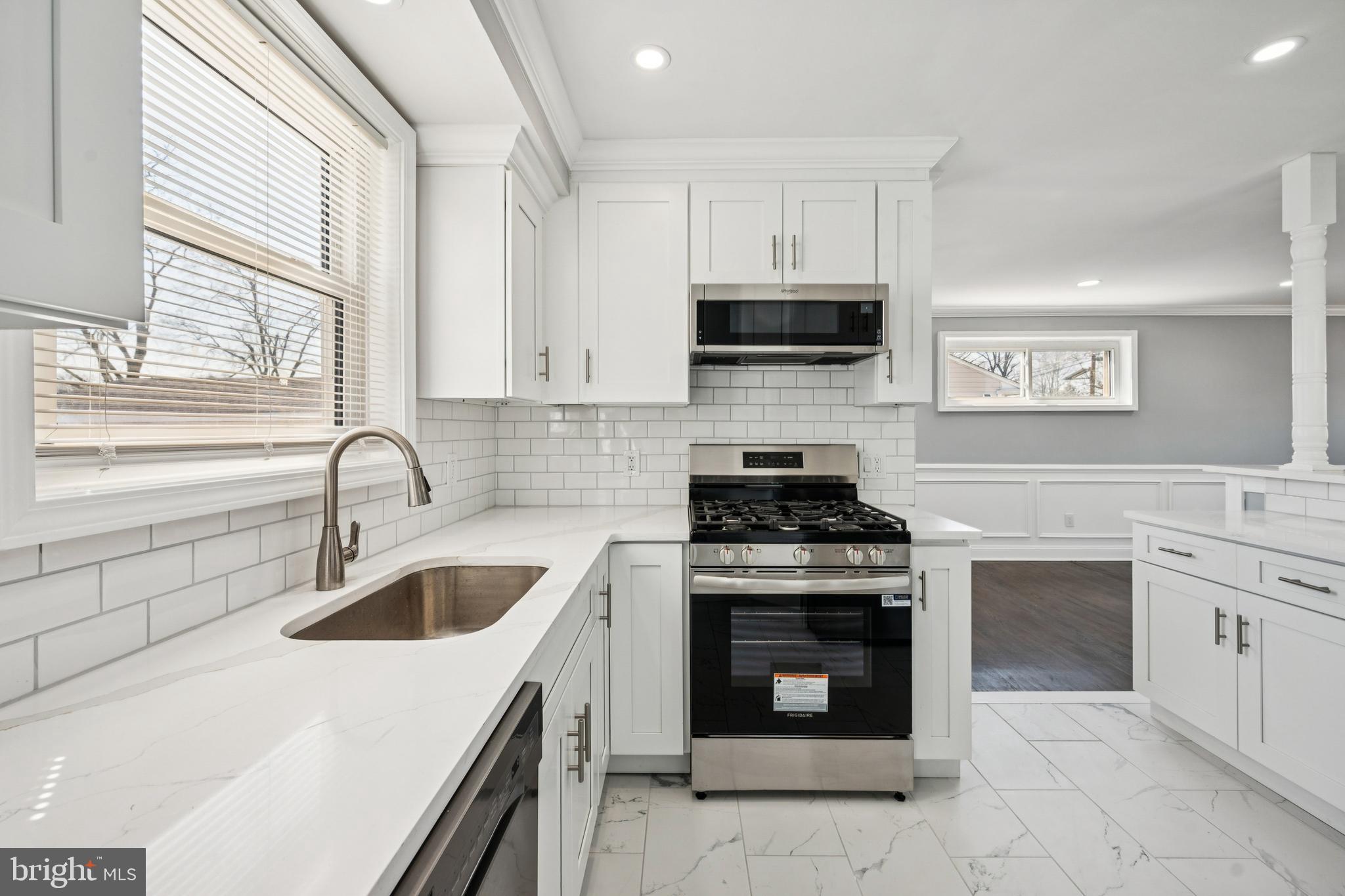 500 West Charles Street Palmyra, NJ 08065 - Photo 8 of 26 a kitchen with white cabinets appliances and a sink