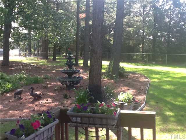 2565 Fairground Road Benson, NC 27504 - Photo 12 of 22 a view of a house with a yard and a garden