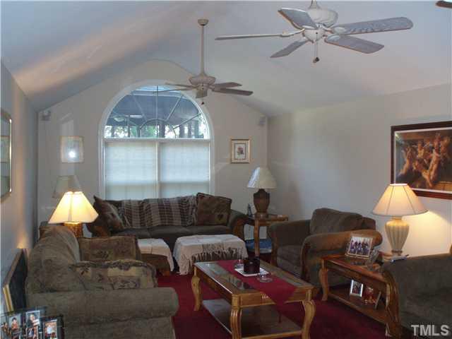 2565 Fairground Road Benson, NC 27504 - Photo 2 of 22 a living room with furniture a rug and a lamp