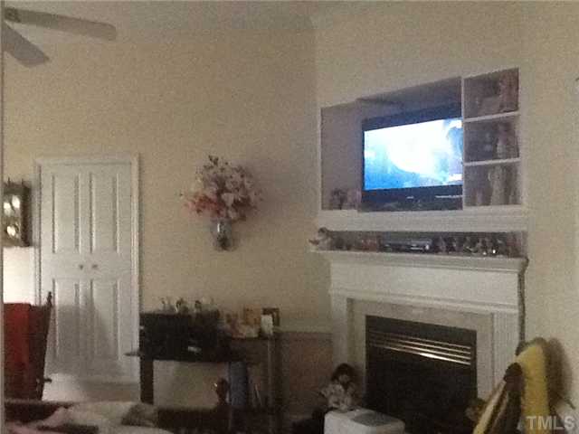 2565 Fairground Road Benson, NC 27504 - Photo 21 of 22 a living room with furniture a fireplace and a flat screen tv