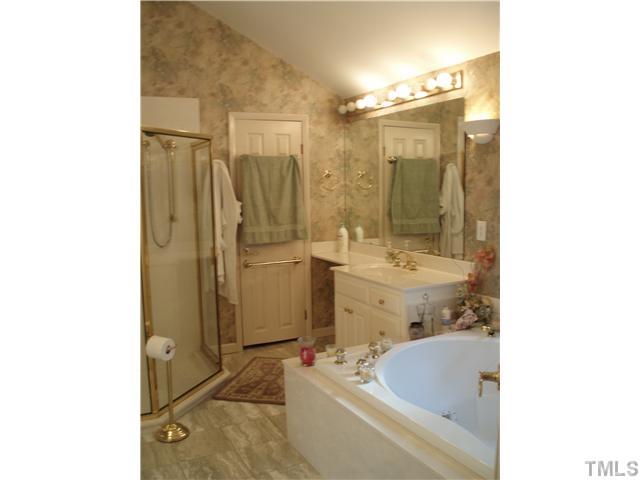 2565 Fairground Road Benson, NC 27504 - Photo 6 of 22 a bathroom with a tub sink shower and mirror