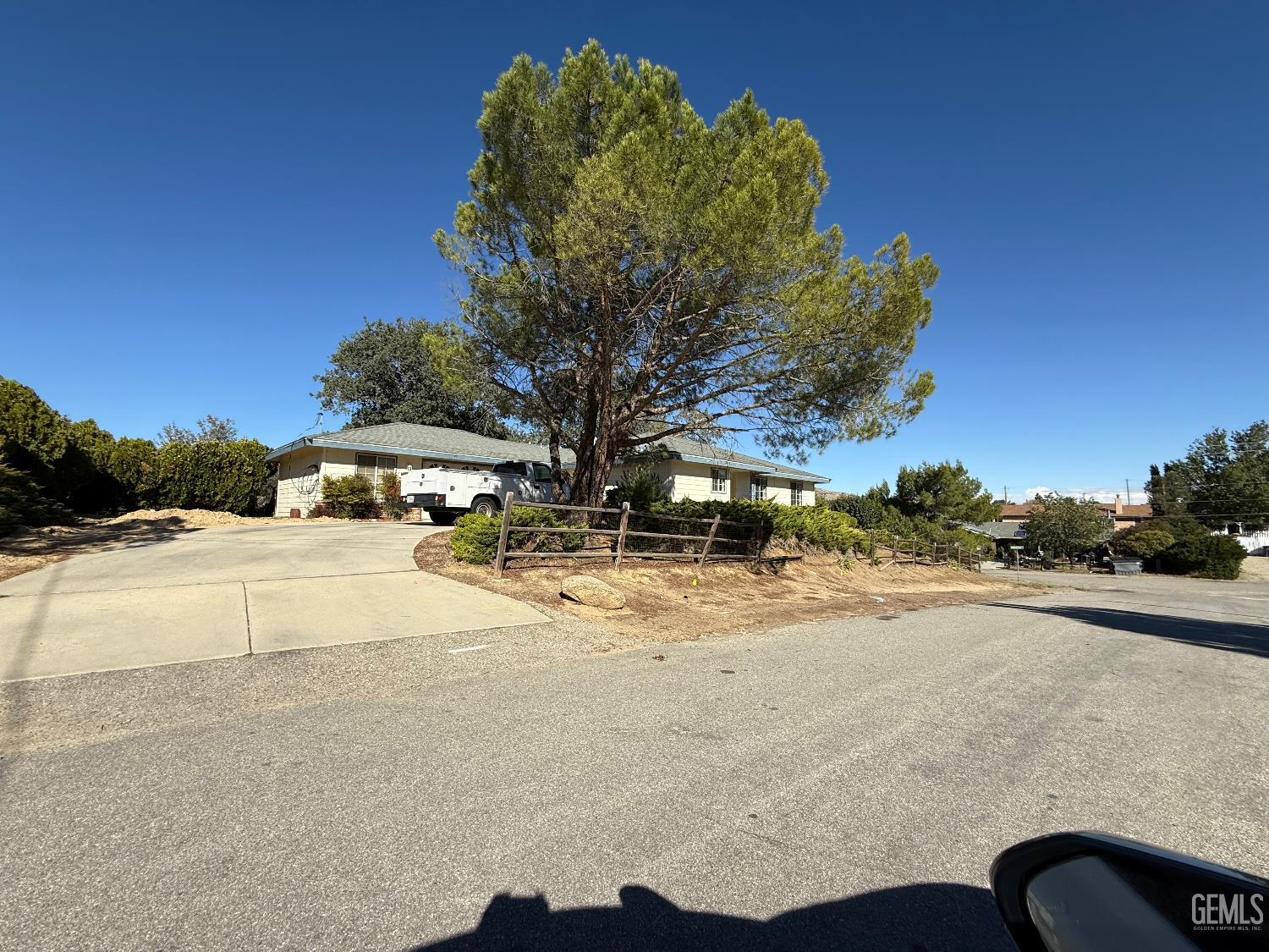 Undisclosed Address Tehachapi, CA 93561 - Photo 2 of 7 a street view with large trees