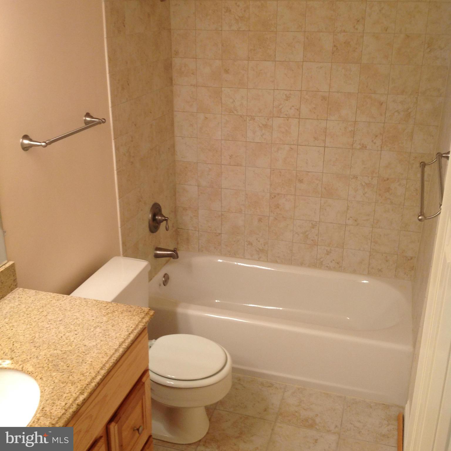 14591 Golden Oak Road Centreville, VA 20121 - Photo 19 of 21 a bathroom with a granite countertop sink toilet and bathtub