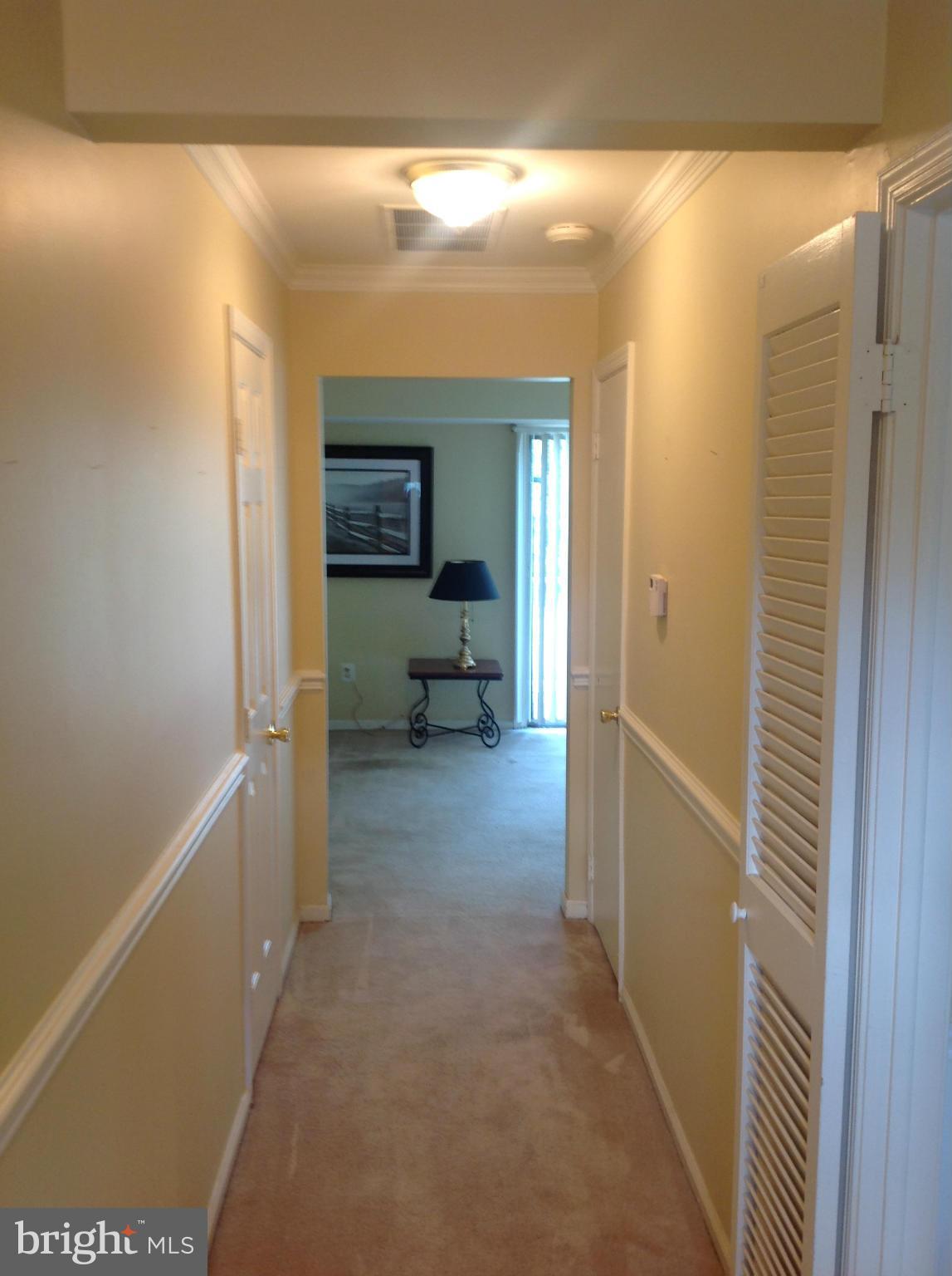 14591 Golden Oak Road Centreville, VA 20121 - Photo 20 of 21 a view of a hallway with furniture and a window