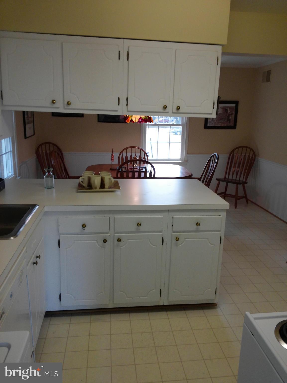 14591 Golden Oak Road Centreville, VA 20121 - Photo 10 of 21 a kitchen with white cabinets and a stove top oven