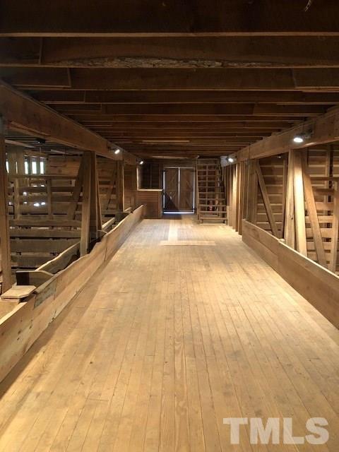 224 Roy Pierce Road Timberlake, NC 27583 - Photo 13 of 23 Unique elevated hallway that looks down into stalls.