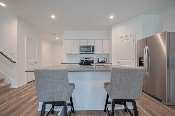 a bathroom with a granite countertop sink a toilet and shower