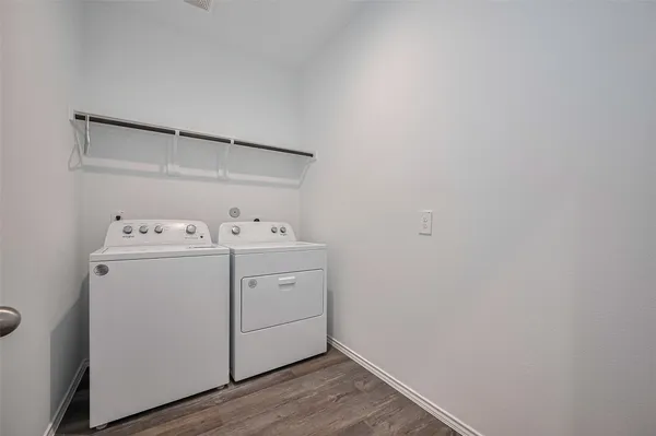 a spacious bedroom with a bed and a table in it