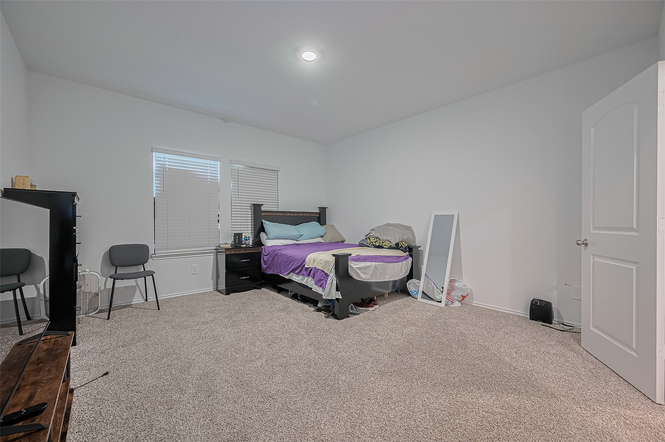 40434 Basalt Elm Road Magnolia, TX 77354 - Photo 19 of 41 a spacious bedroom with a bed and a table in it