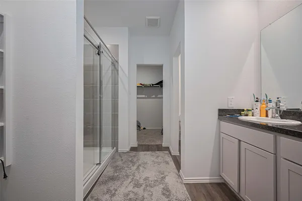 a bathroom with a granite countertop sink a toilet and a mirror