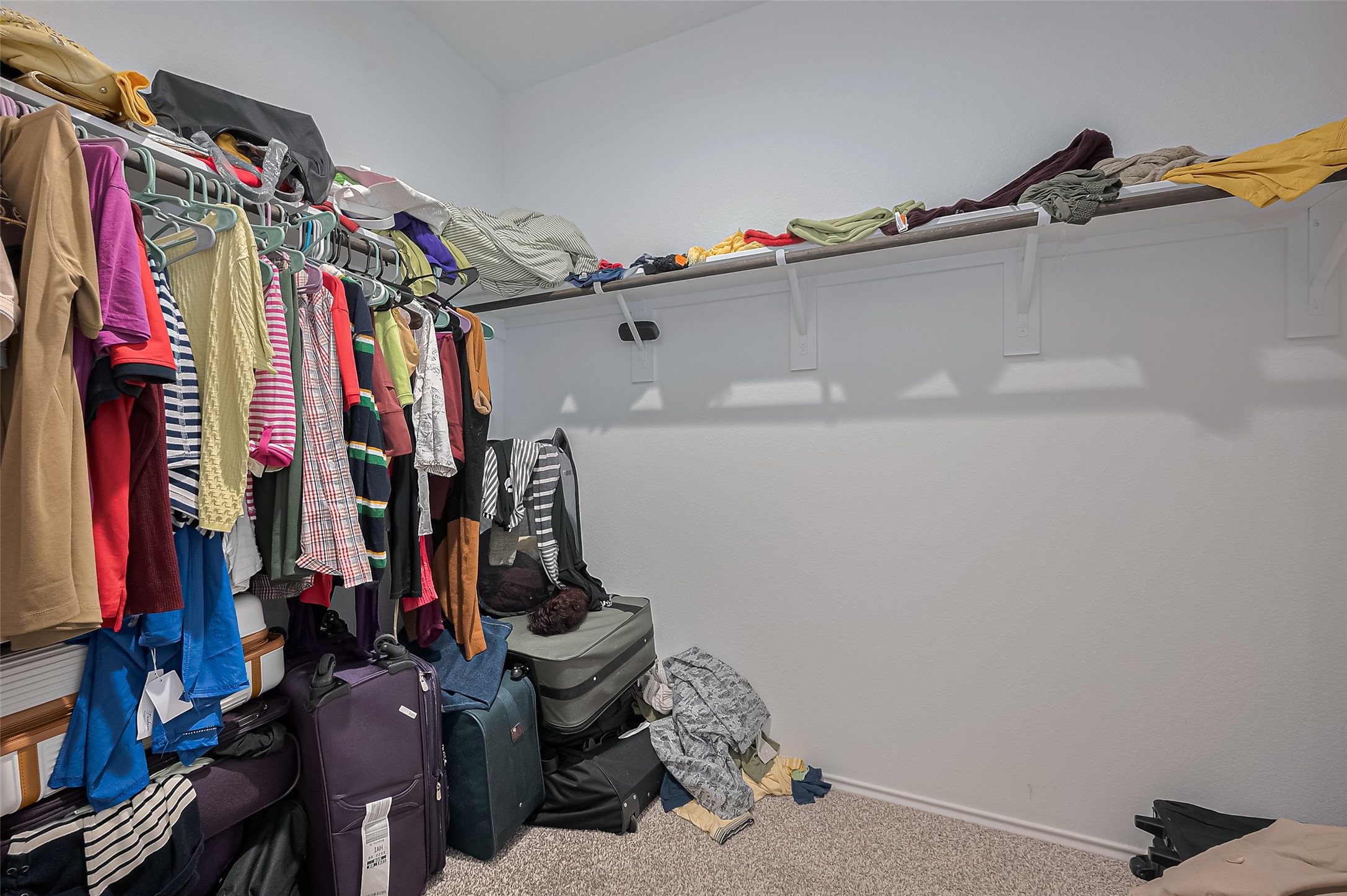 40434 Basalt Elm Road Magnolia, TX 77354 - Photo 24 of 41 a view of walk in closet with clothes and shoes