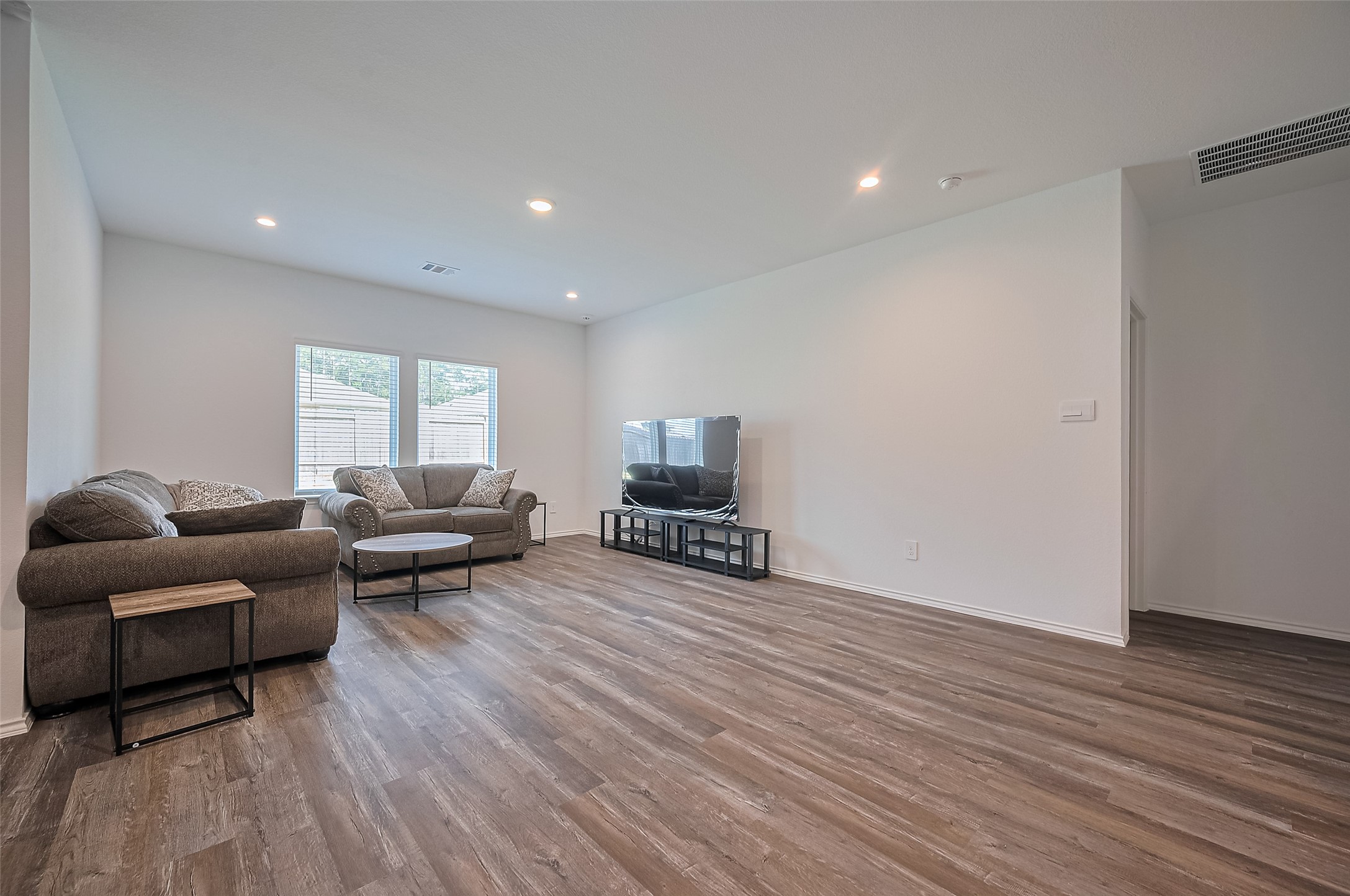 40434 Basalt Elm Road Magnolia, TX 77354 - Photo 6 of 41 a living room with furniture and a wooden floor