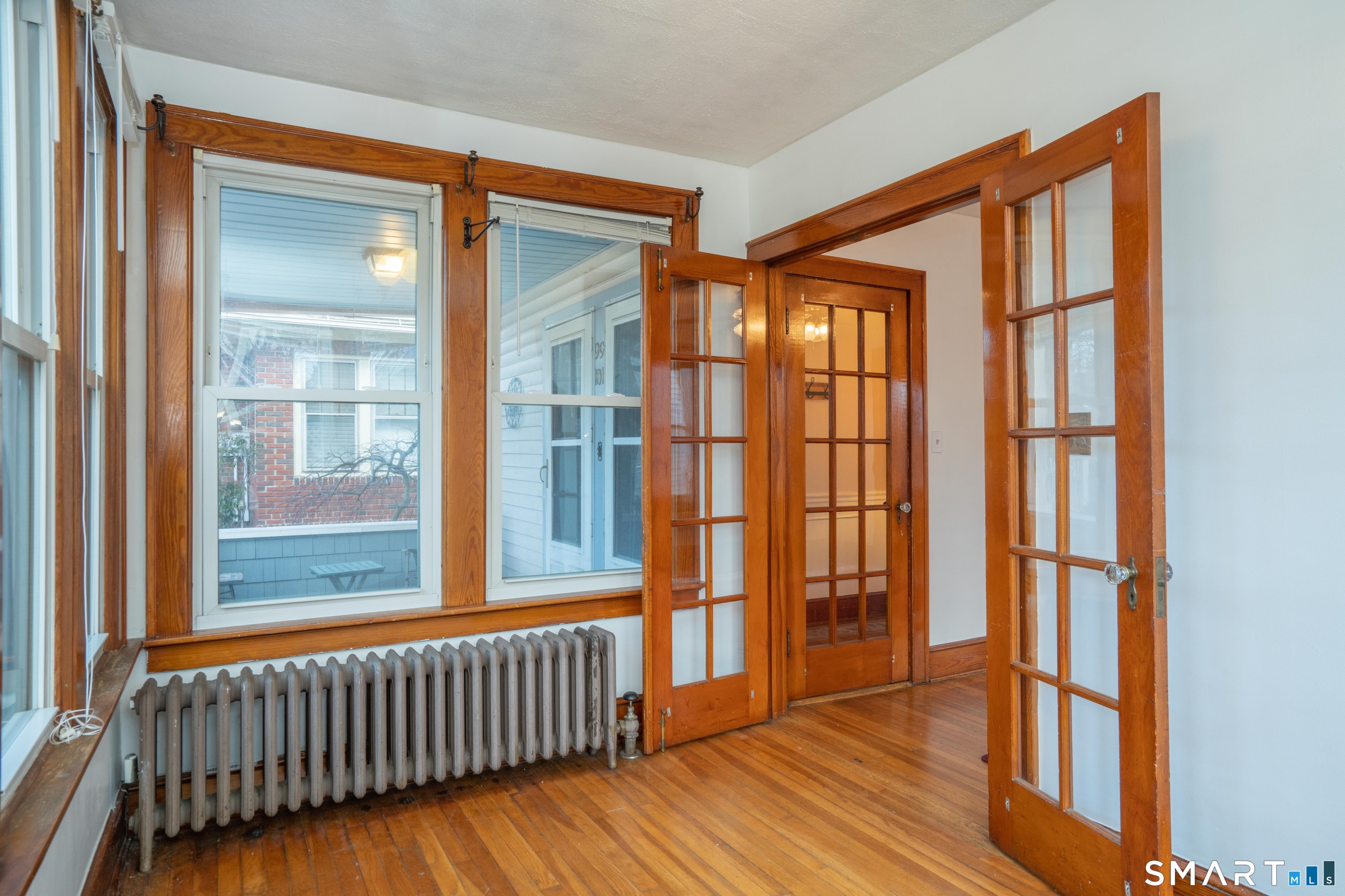 99 Queen Street Bristol, CT 06010 - Photo 10 of 39 Hardwood floors and french doors lead to the living room