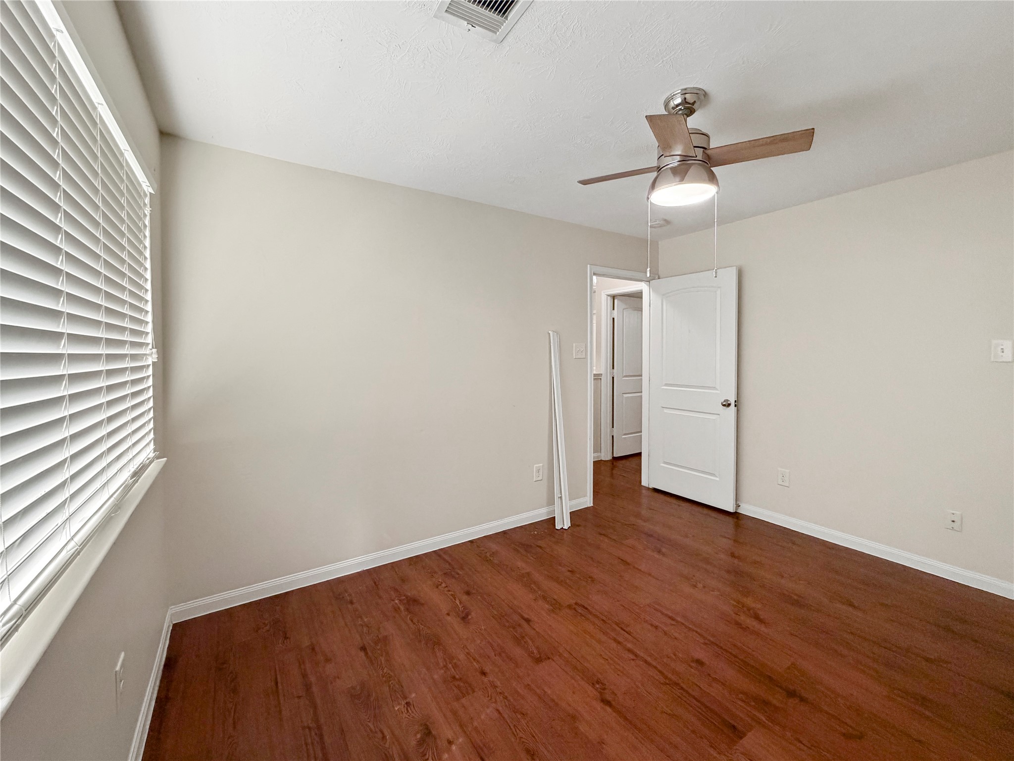 3542 Maris Way Humble, TX 77338 - Photo 15 of 21 an empty room with wooden floor fan and windows