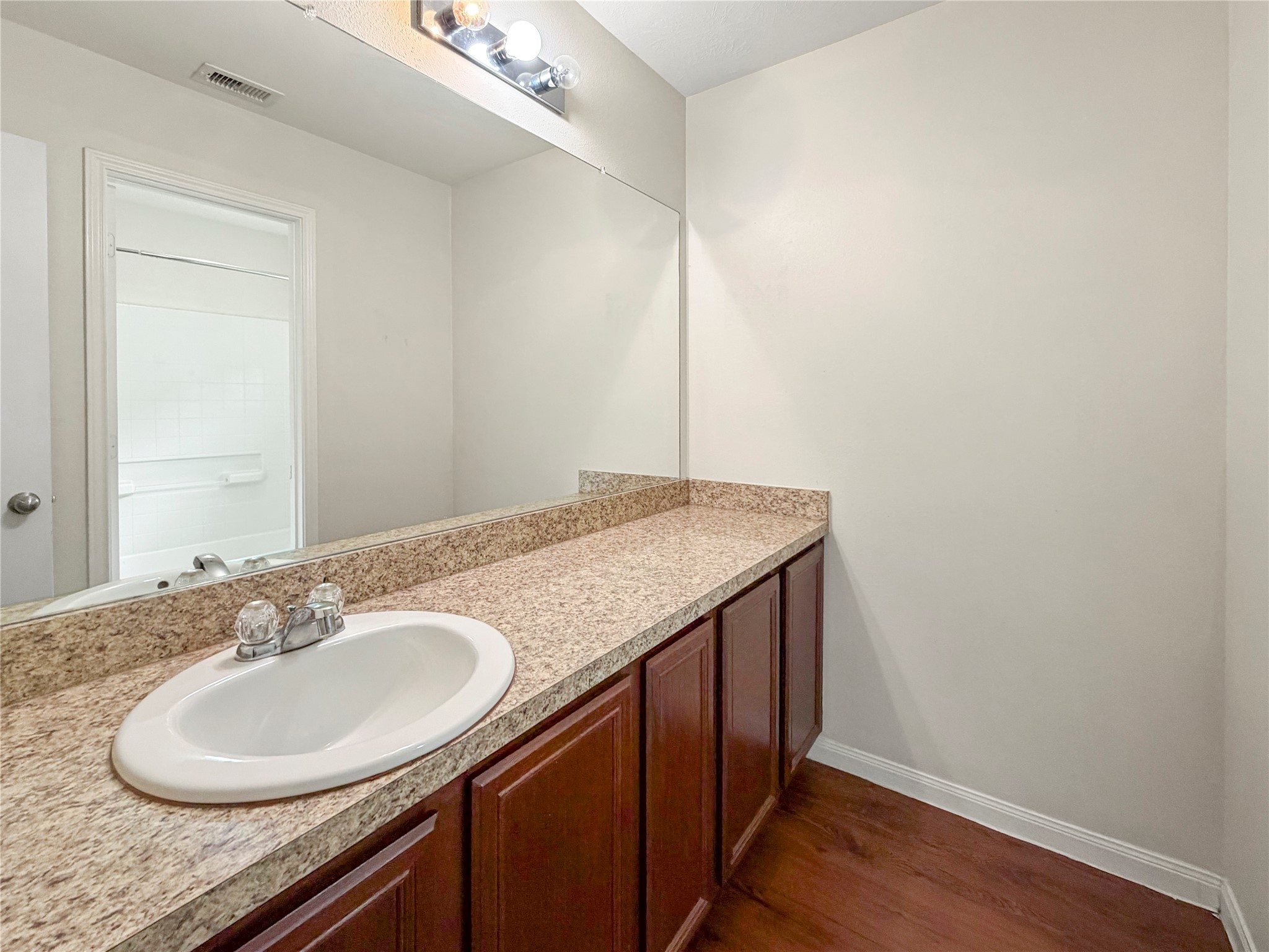 3542 Maris Way Humble, TX 77338 - Photo 17 of 21 a bathroom with a granite countertop sink a mirror and vanity