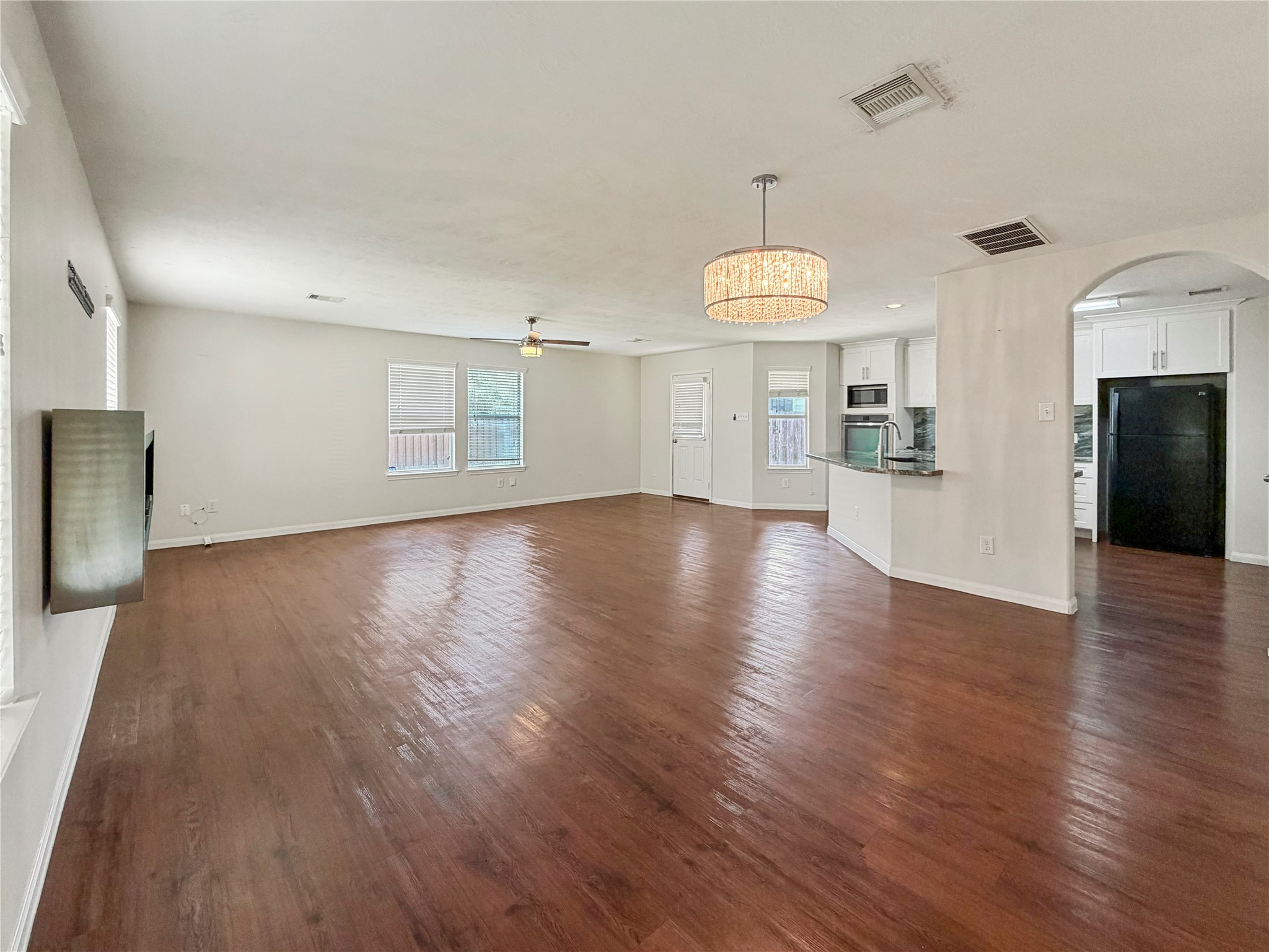 3542 Maris Way Humble, TX 77338 - Photo 4 of 21 a view of an empty room with wooden floor and a window