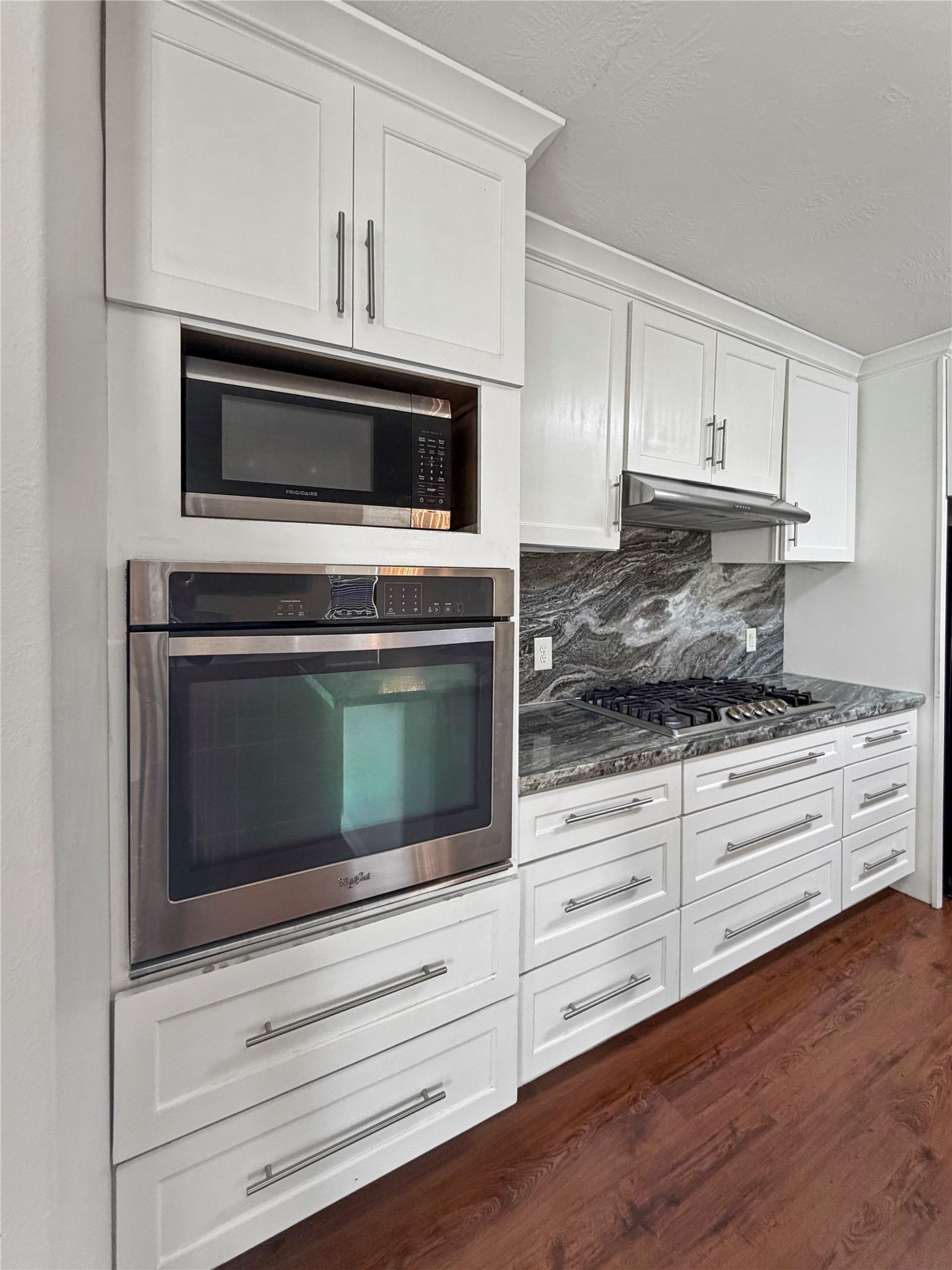 3542 Maris Way Humble, TX 77338 - Photo 7 of 21 a kitchen with granite countertop cabinets stainless steel appliances and wooden floor