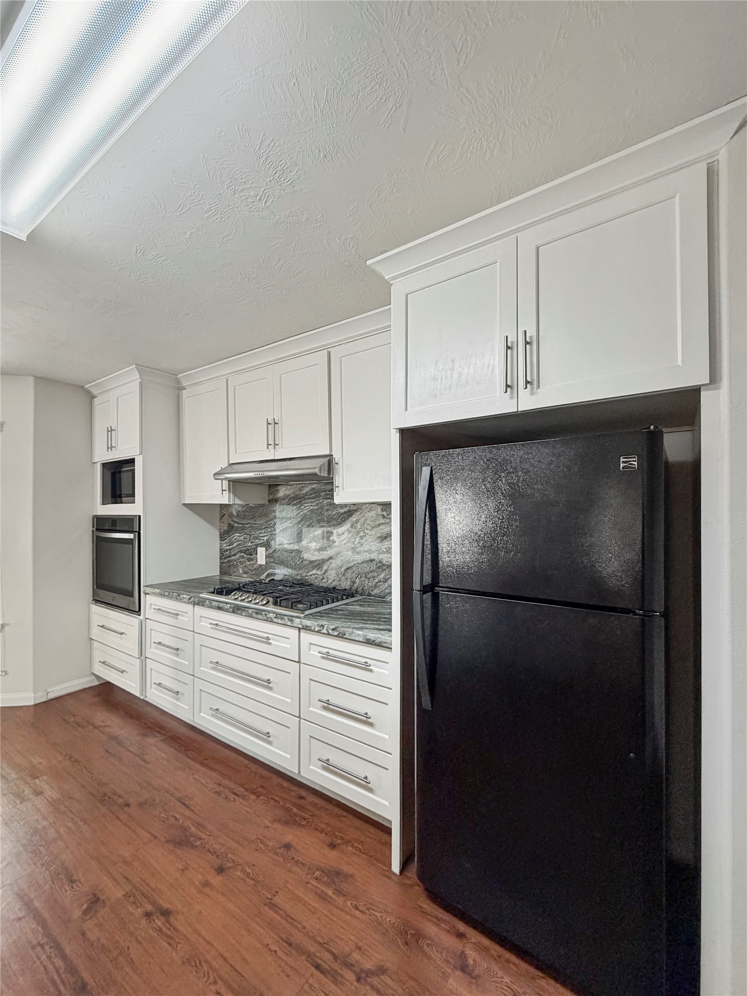 3542 Maris Way Humble, TX 77338 - Photo 8 of 21 a kitchen with a refrigerator and a stove top oven