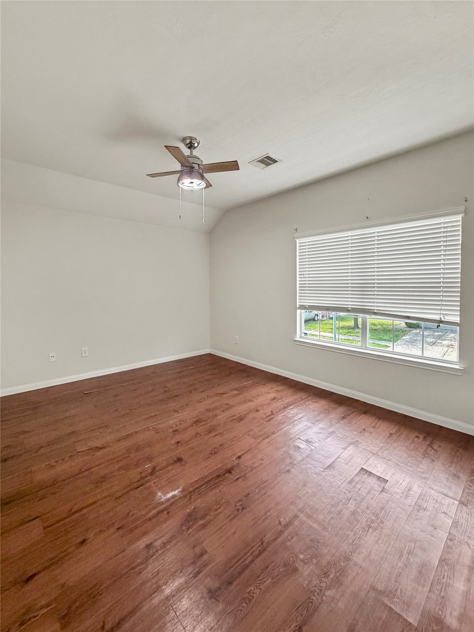 3542 Maris Way Humble, TX 77338 - Photo 9 of 21 an empty room with wooden floor ceiling fan and windows