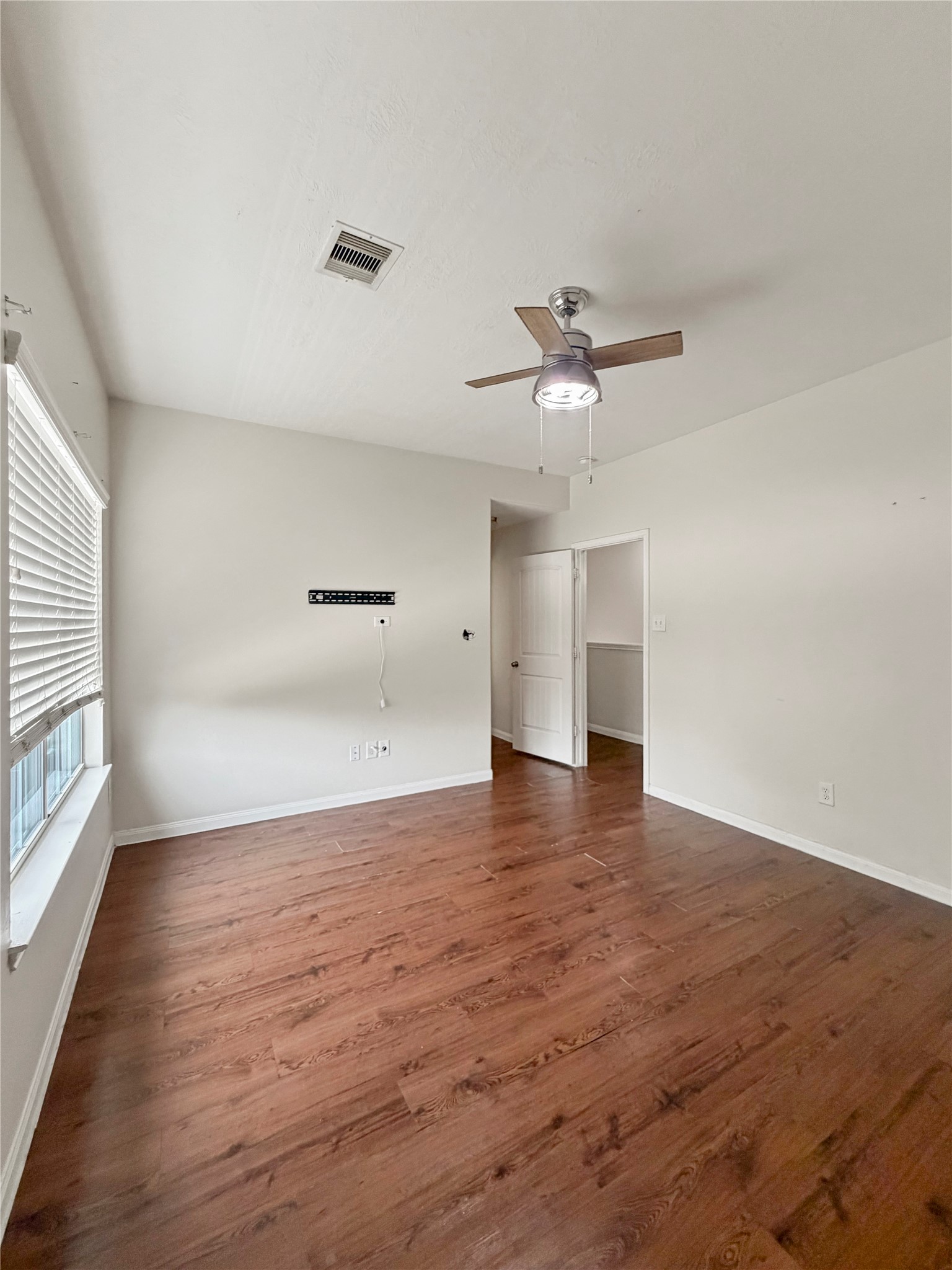 3542 Maris Way Humble, TX 77338 - Photo 10 of 21 wooden floor in an empty room with a window