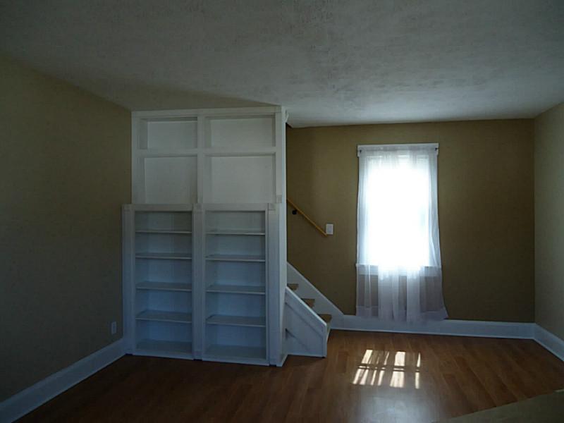 1408 Darlington Road Beaver Falls, PA 15010 - Photo 4 of 24 Living Room. Custom built-in shelving next to stairs.
