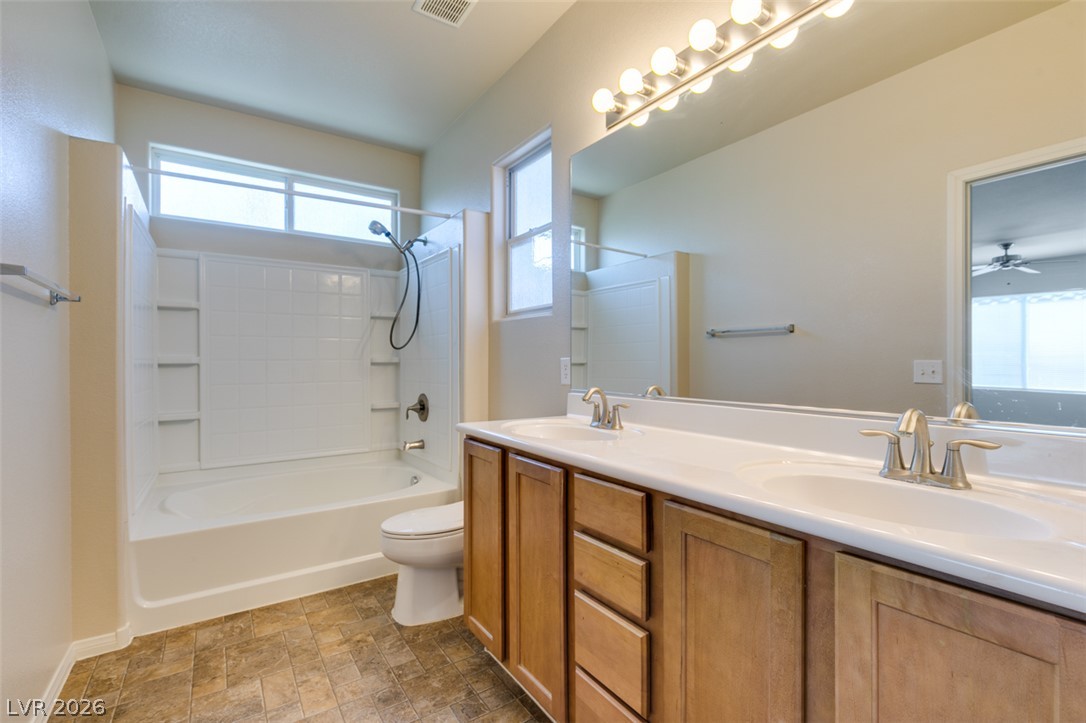 8937 Caledon Ridge Court Las Vegas, NV 89149 - Photo 37 of 43 Dual vanities complement a bright bathroom featuring a convenient tub and shower combination.