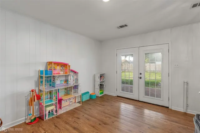 a play room with toys and a wooden floor