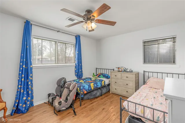 a bedroom with a bed and a dresser in it