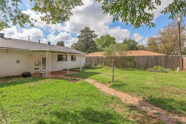 a view of a backyard with large trees