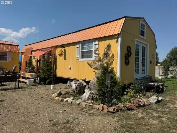 a front view of a house with sitting space