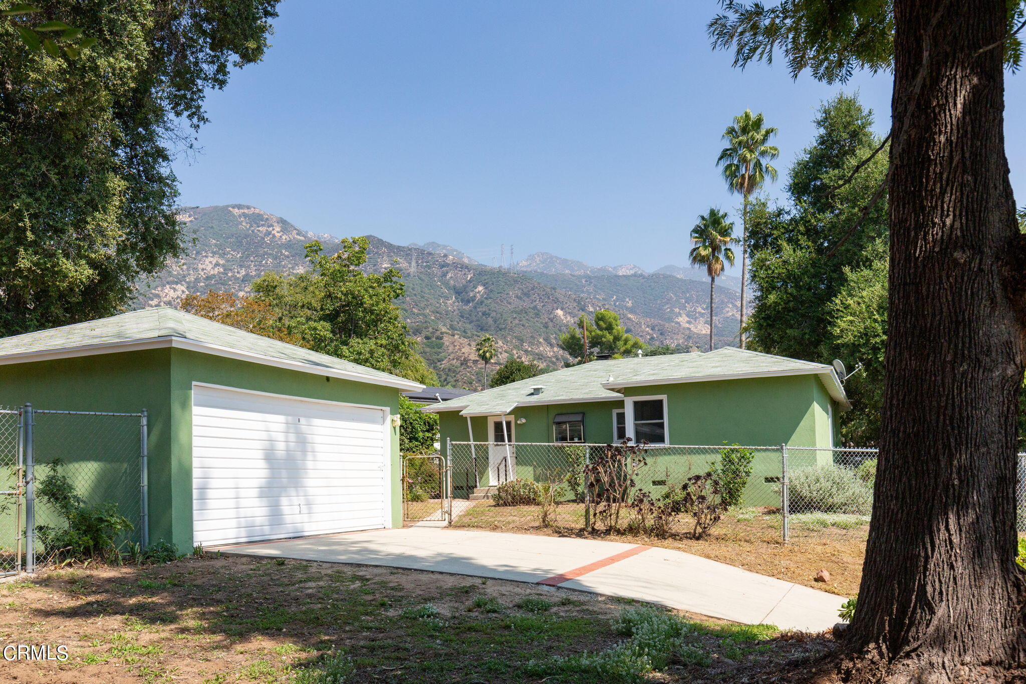 3565 McNally Avenue Altadena, CA 91001 - Photo 21 of 33 a patio with a table and chairs under an umbrella