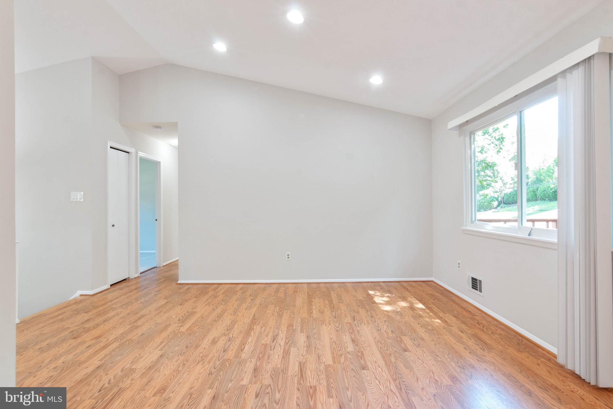 14217 Piccadilly Road Silver Spring, MD 20906 - Photo 11 of 38 an empty room with wooden floor and windows