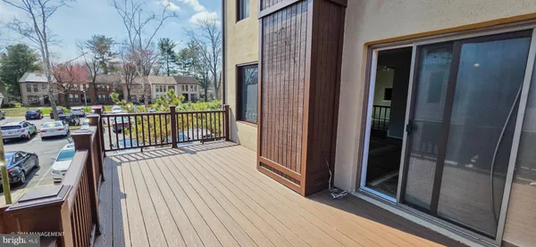 a view of a balcony with wooden floor