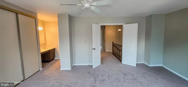 a view of a hallway with wooden shelves