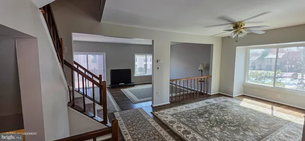 a view of an entryway wooden floor and chandelier
