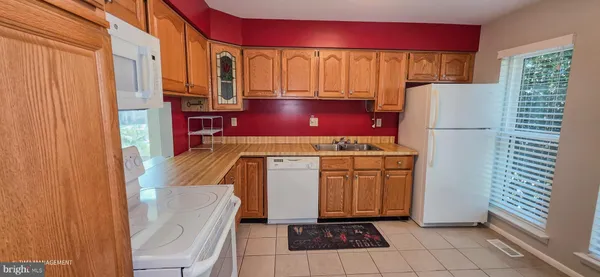 a kitchen with a refrigerator and a stove